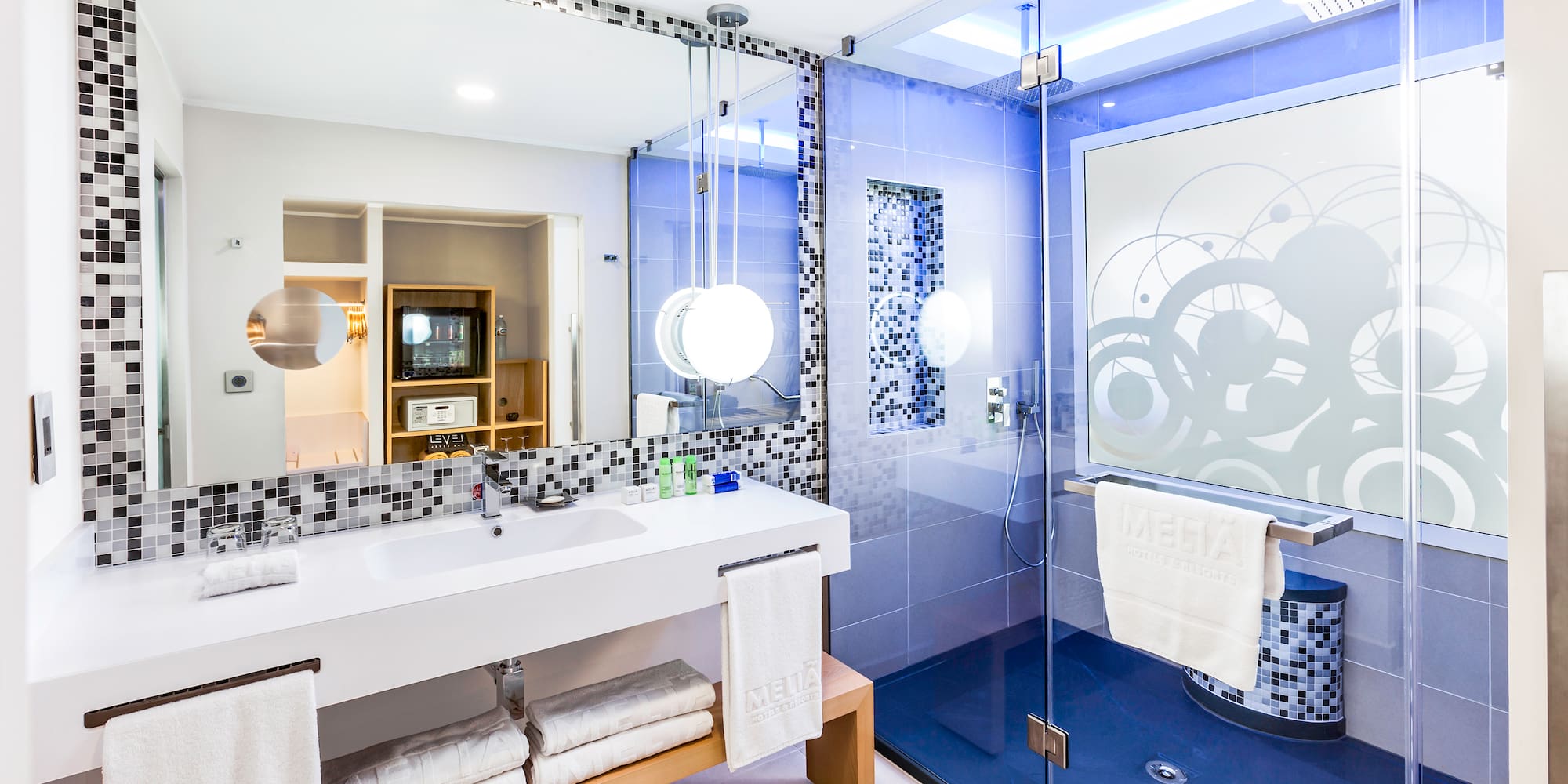 a bathroom with a glass shower and a sink