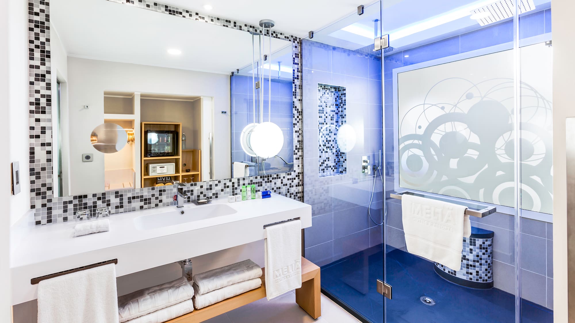 a bathroom with a glass shower and a sink