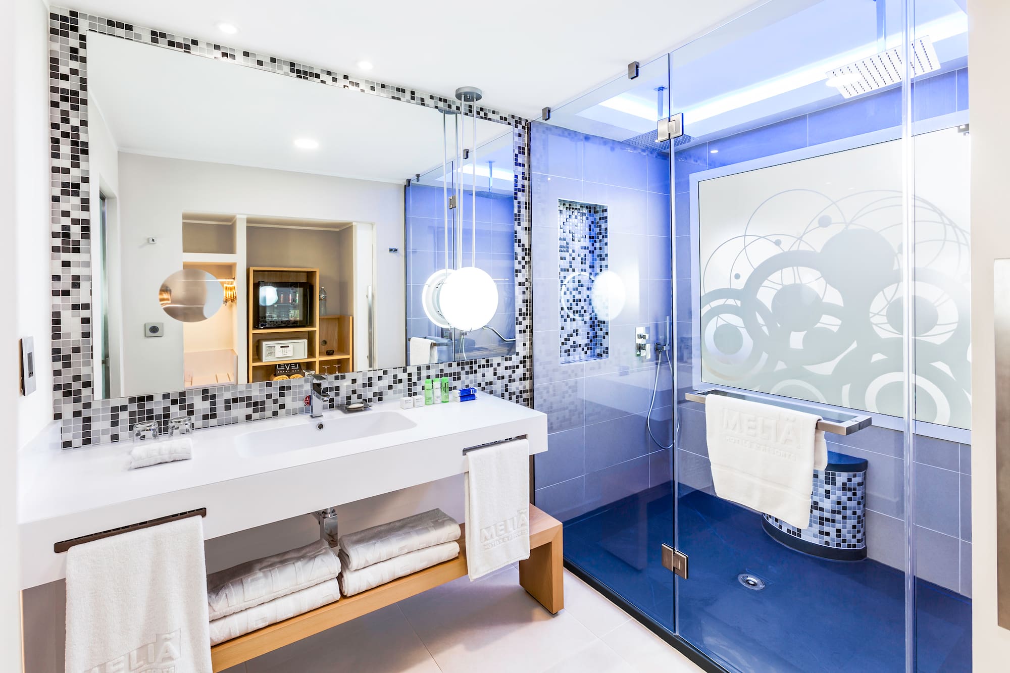 a bathroom with a glass shower and a sink