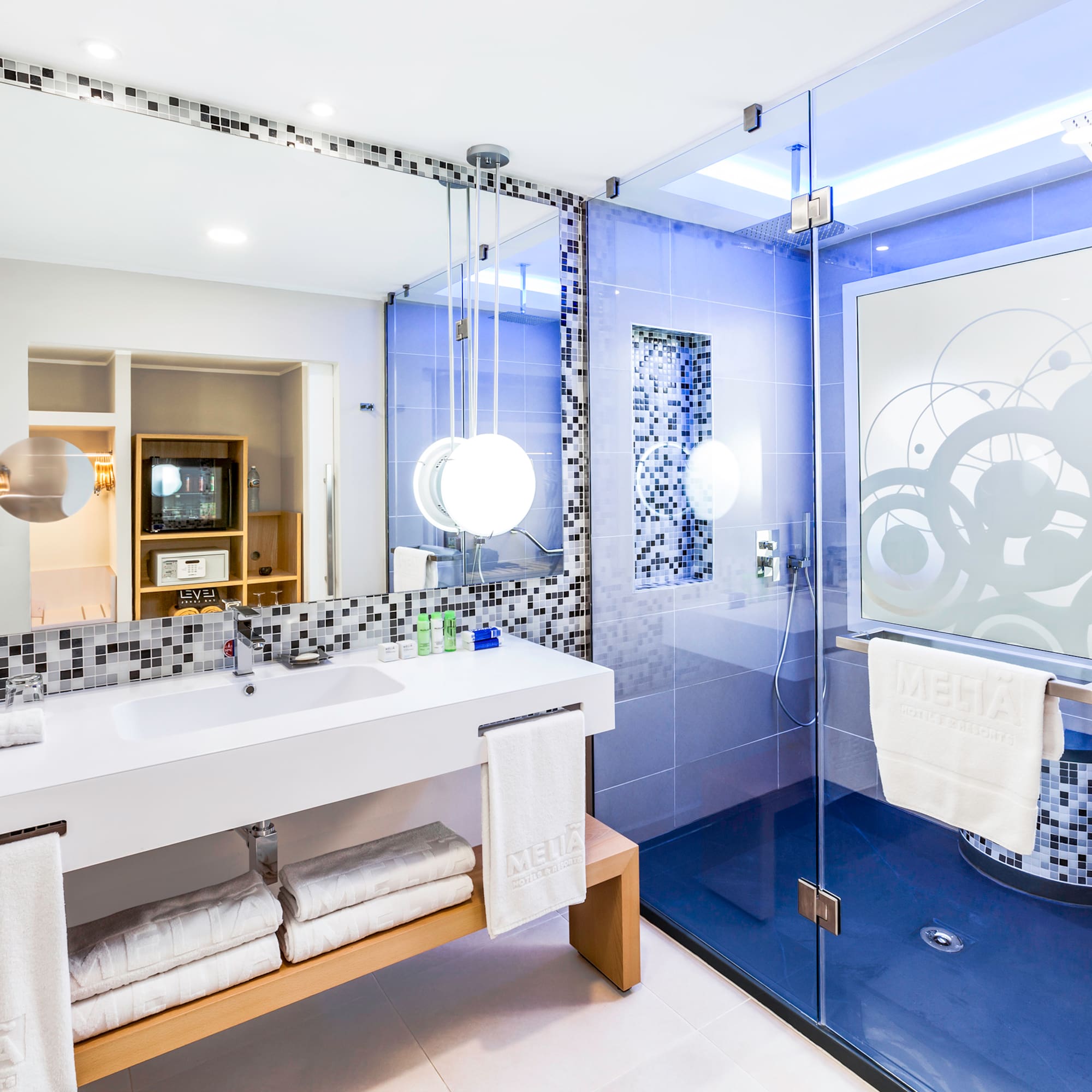 a bathroom with a glass shower and a sink