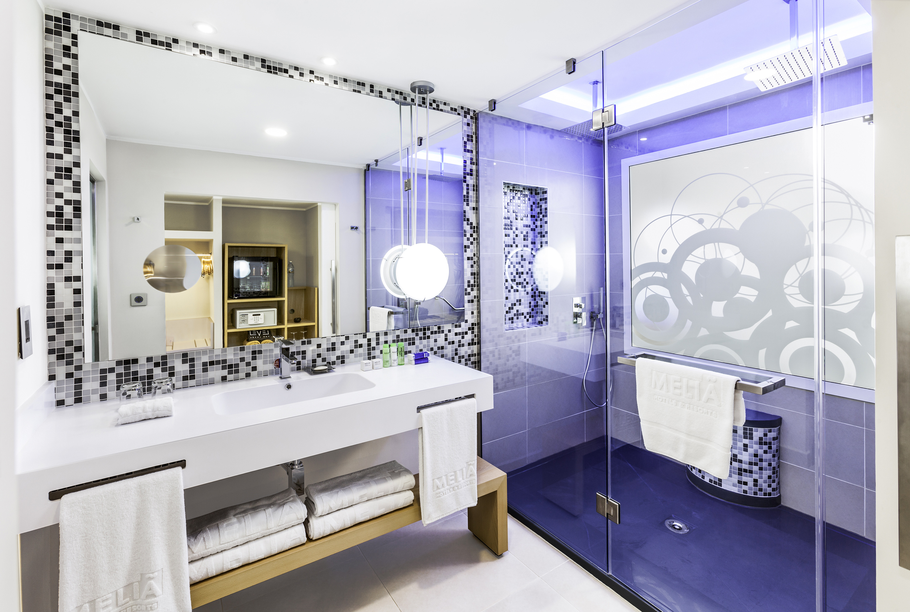 a bathroom with a glass shower and a sink