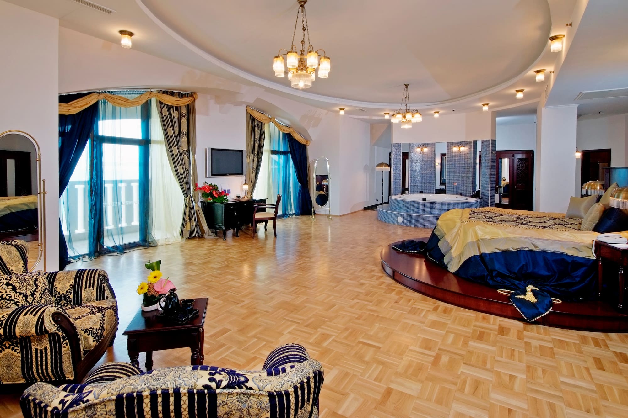 a room with a round bed and a jacuzzi