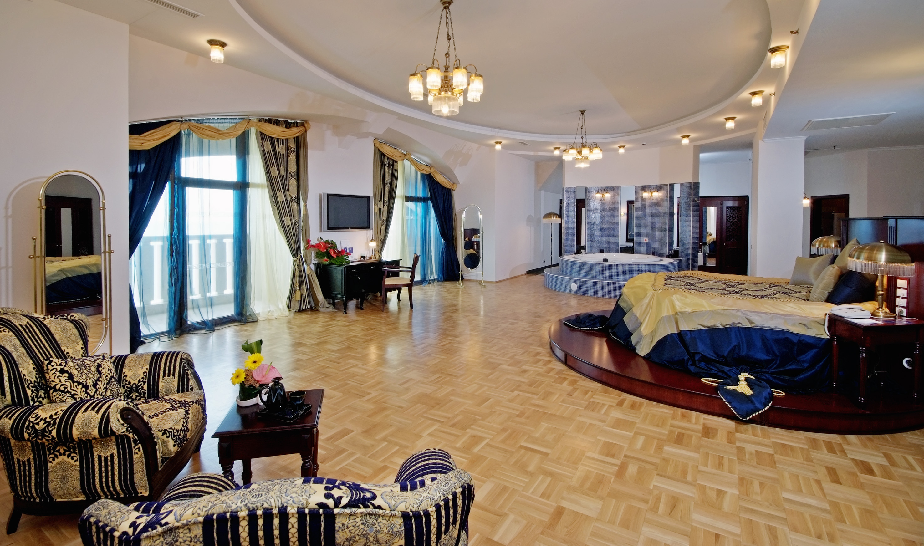 a room with a round bed and a jacuzzi