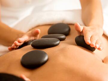 a person getting a hot stone massage