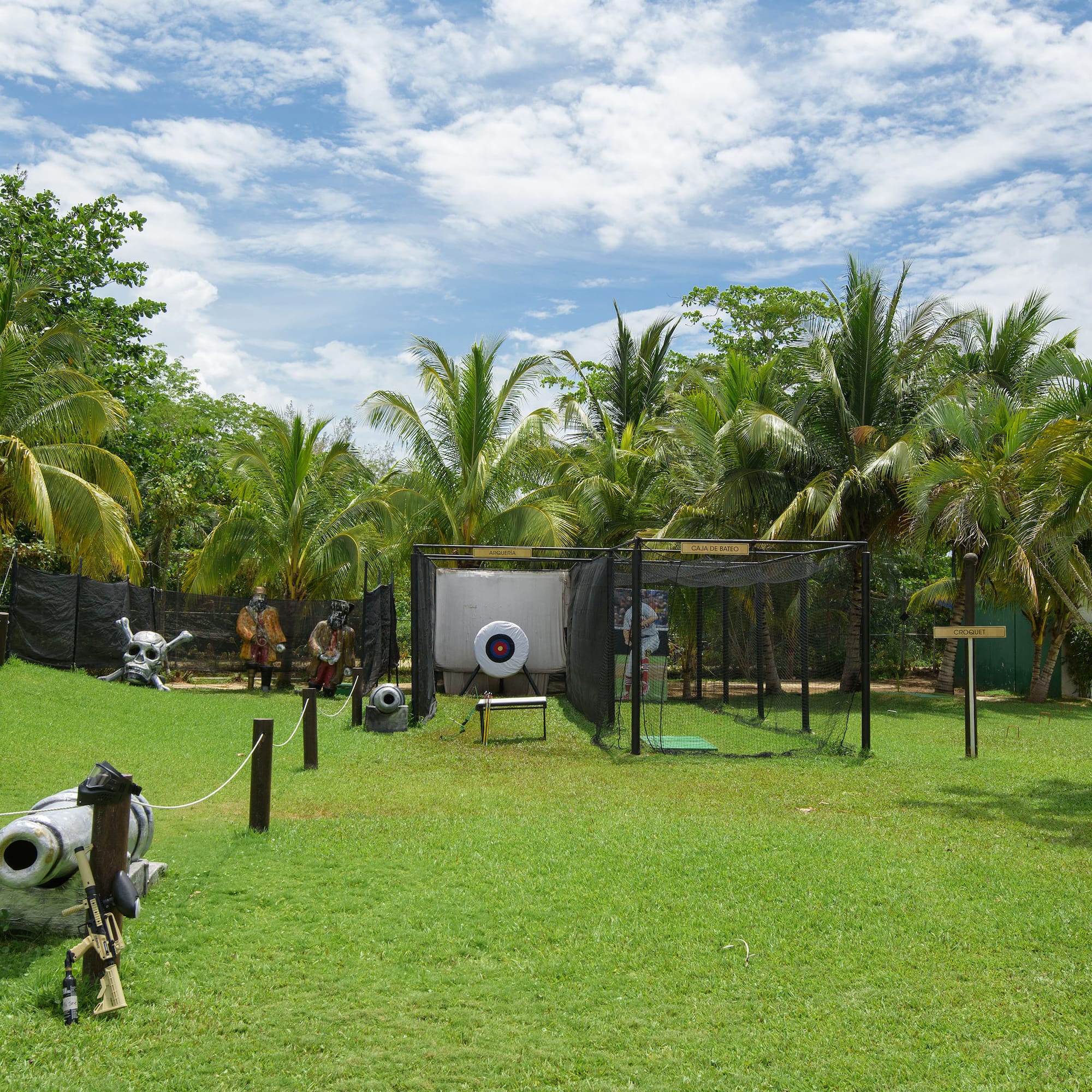 a playground with a gun and a gun in the middle of a field