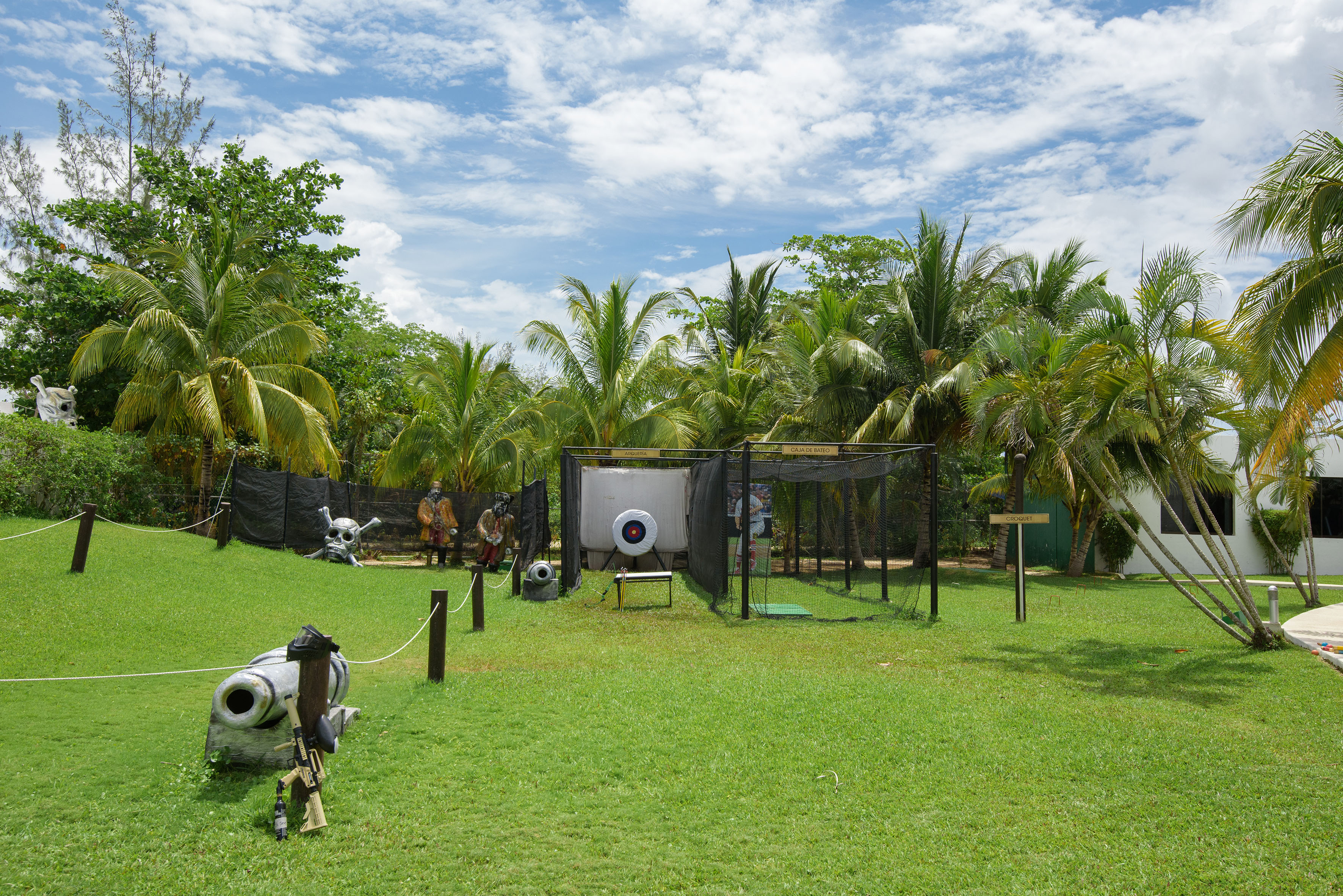a playground with a gun and a gun in the middle of a field
