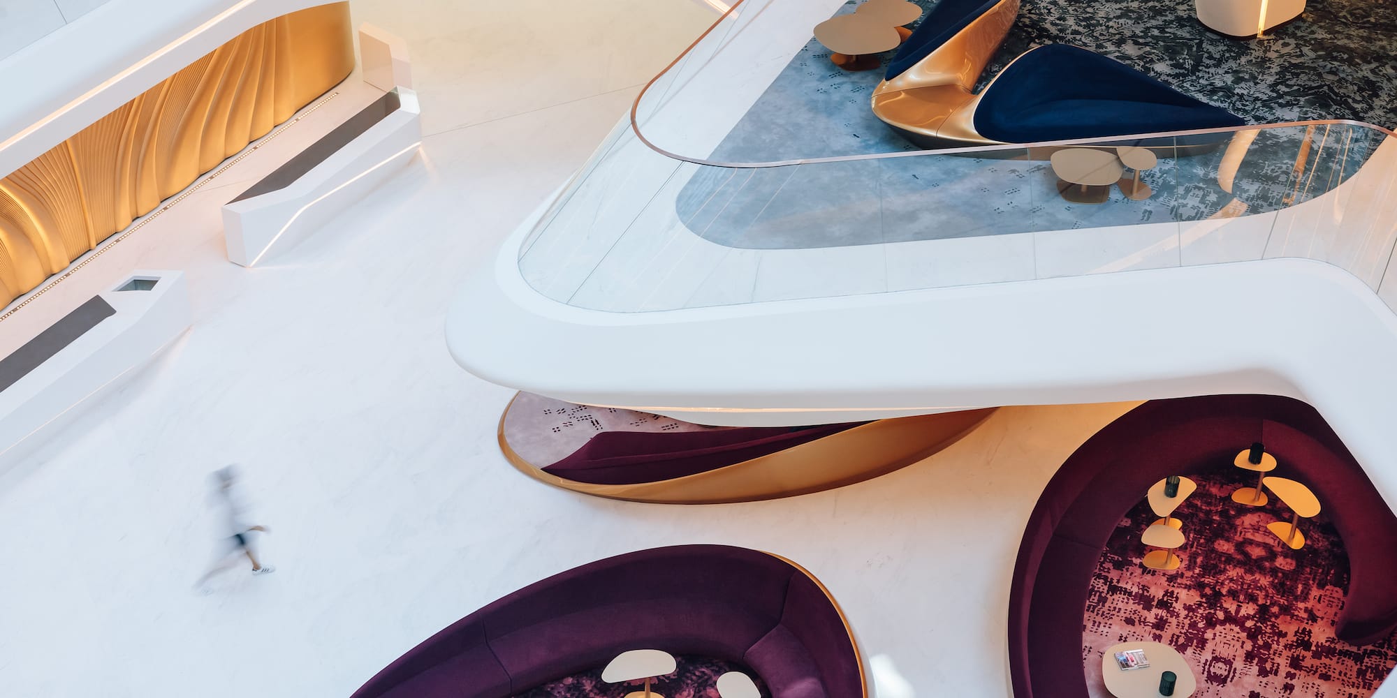 a room with a large round table and chairs