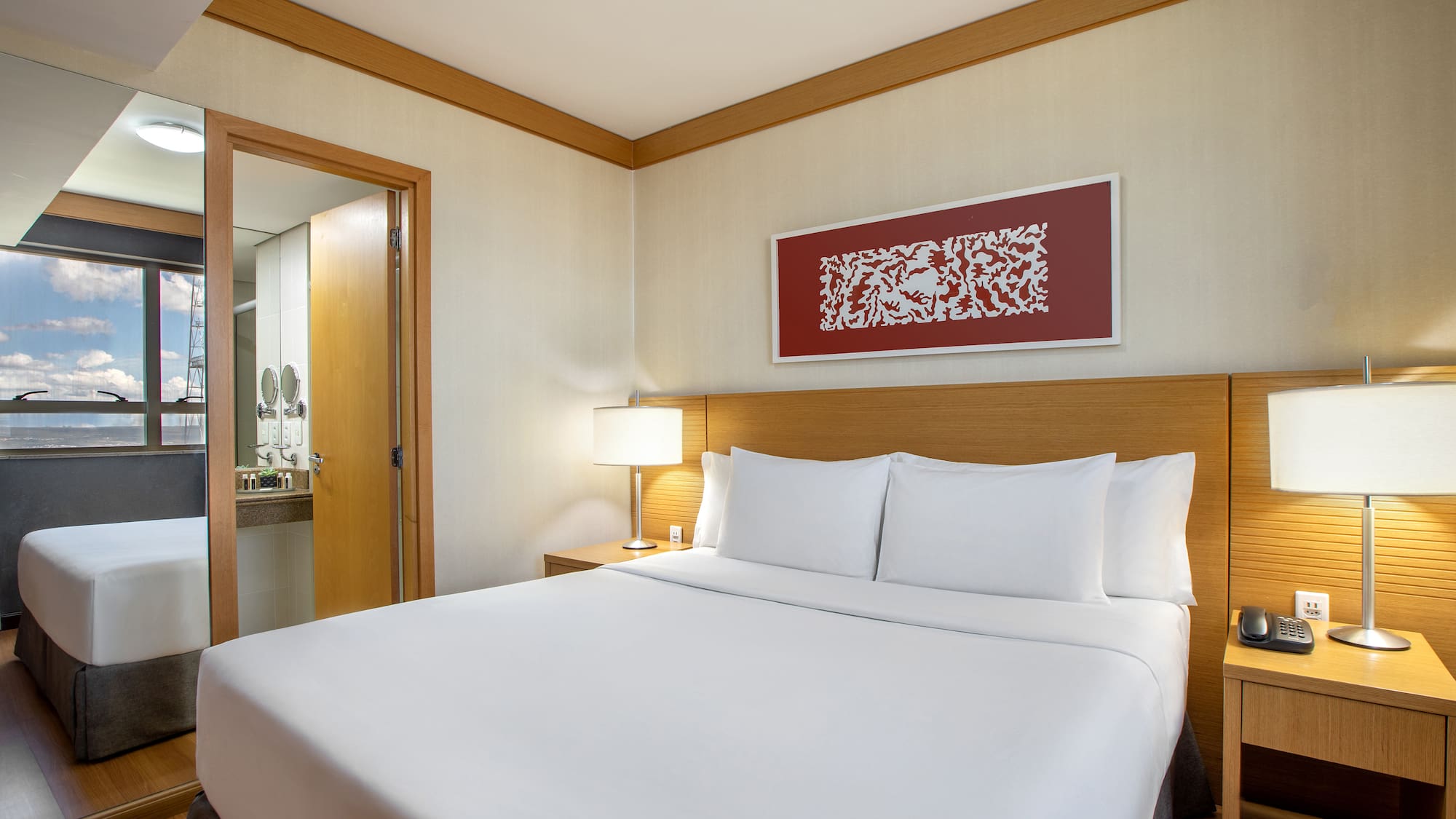 a bed with white sheets and a lamp