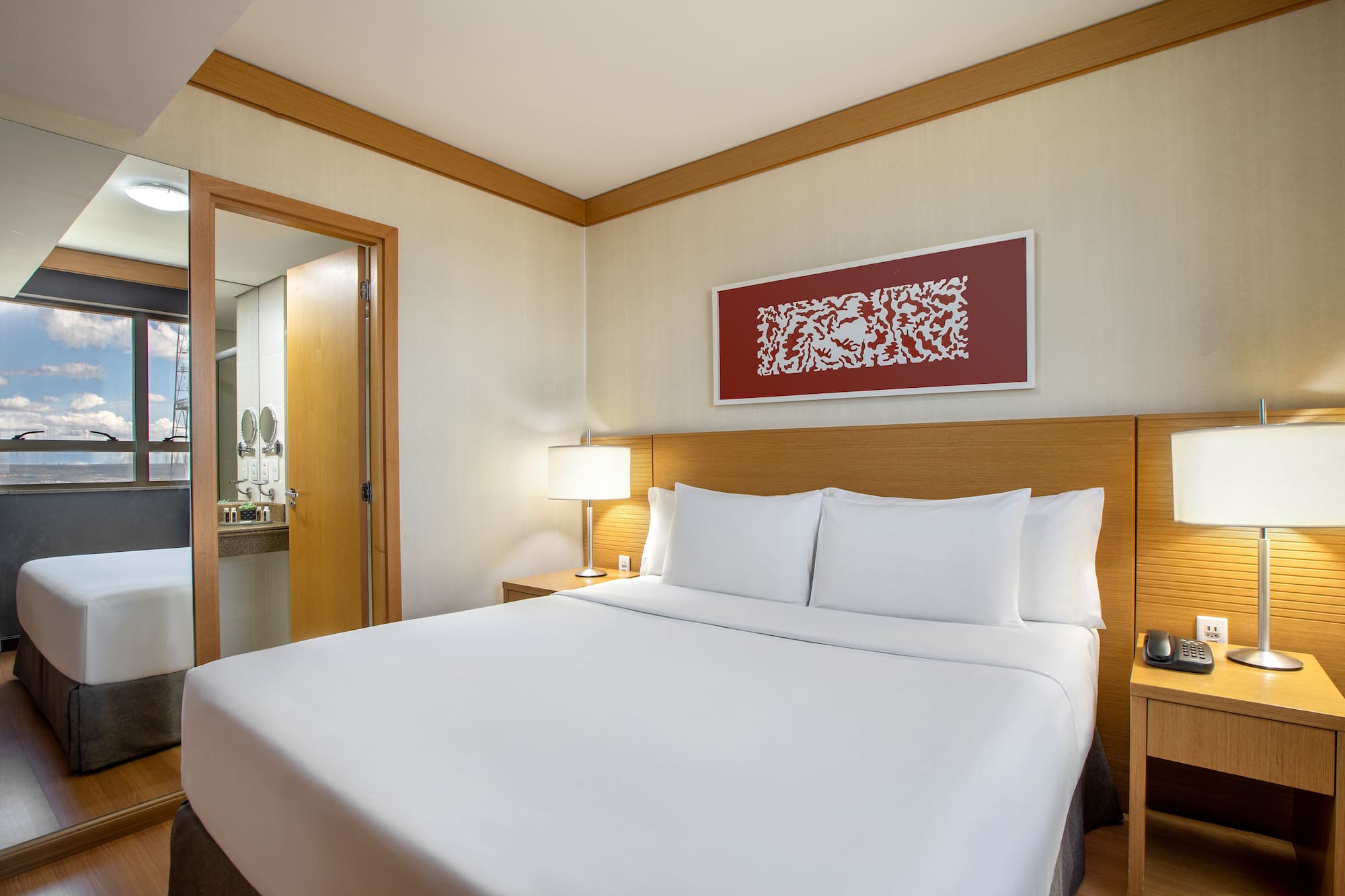 a bed with white sheets and a lamp