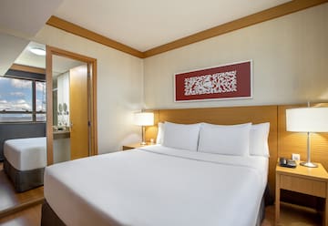 a bed with white sheets and a lamp