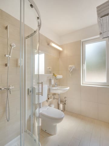 a bathroom with a shower and toilet