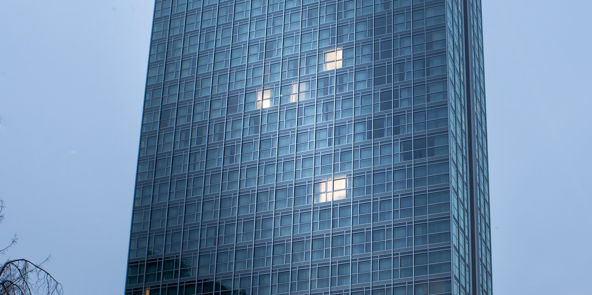 a room with a bar and tables and plants
