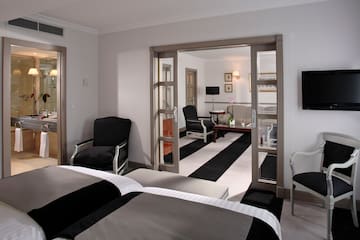 a room with two beds and a black and white striped carpet