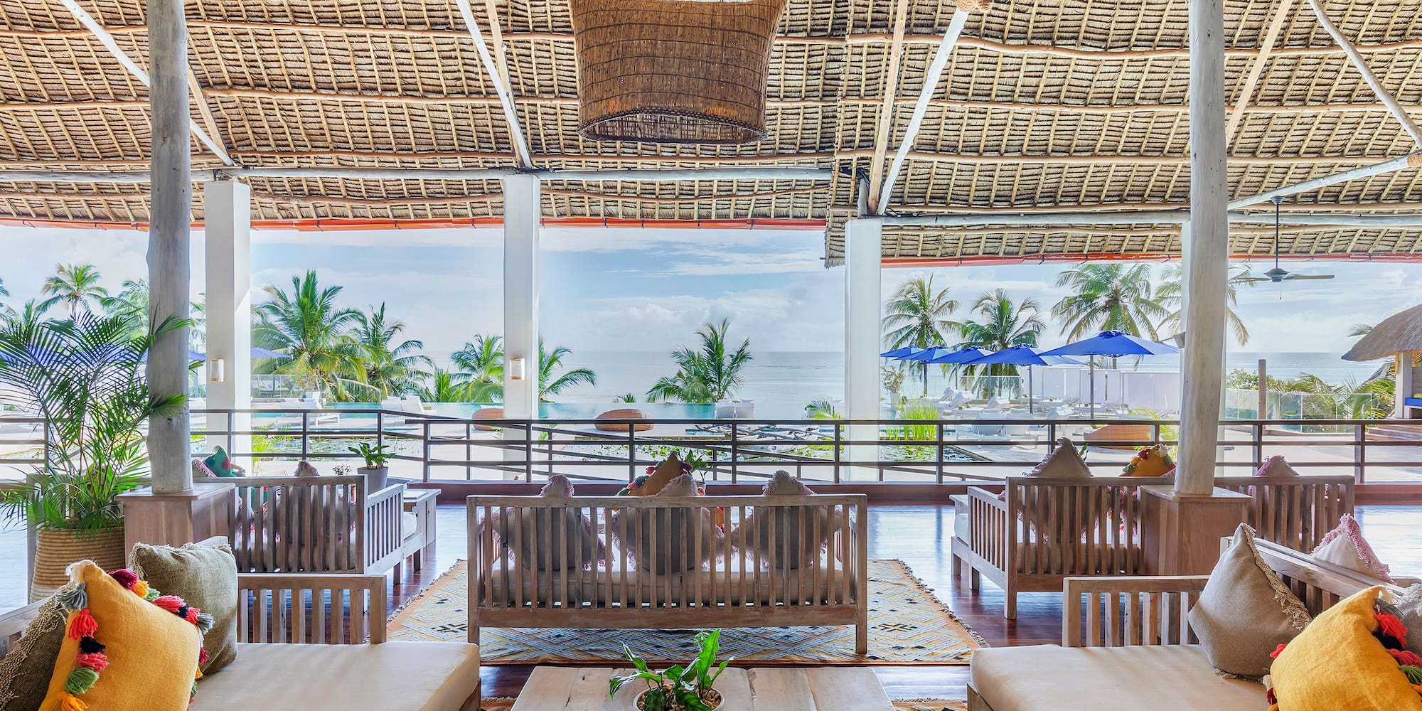 a room with a large roof and chairs and a table
