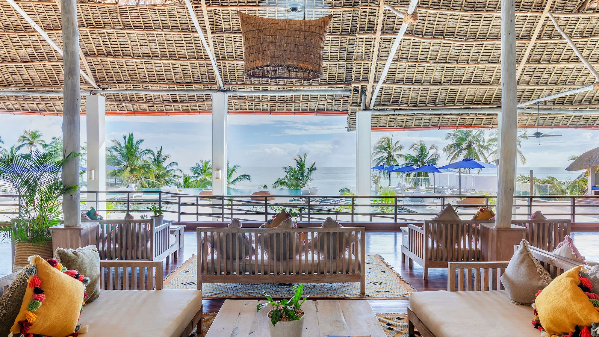 a room with a large roof and chairs and a table
