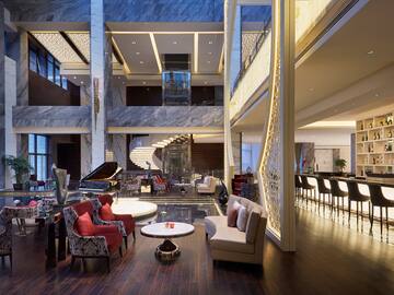 a lobby with a piano and chairs