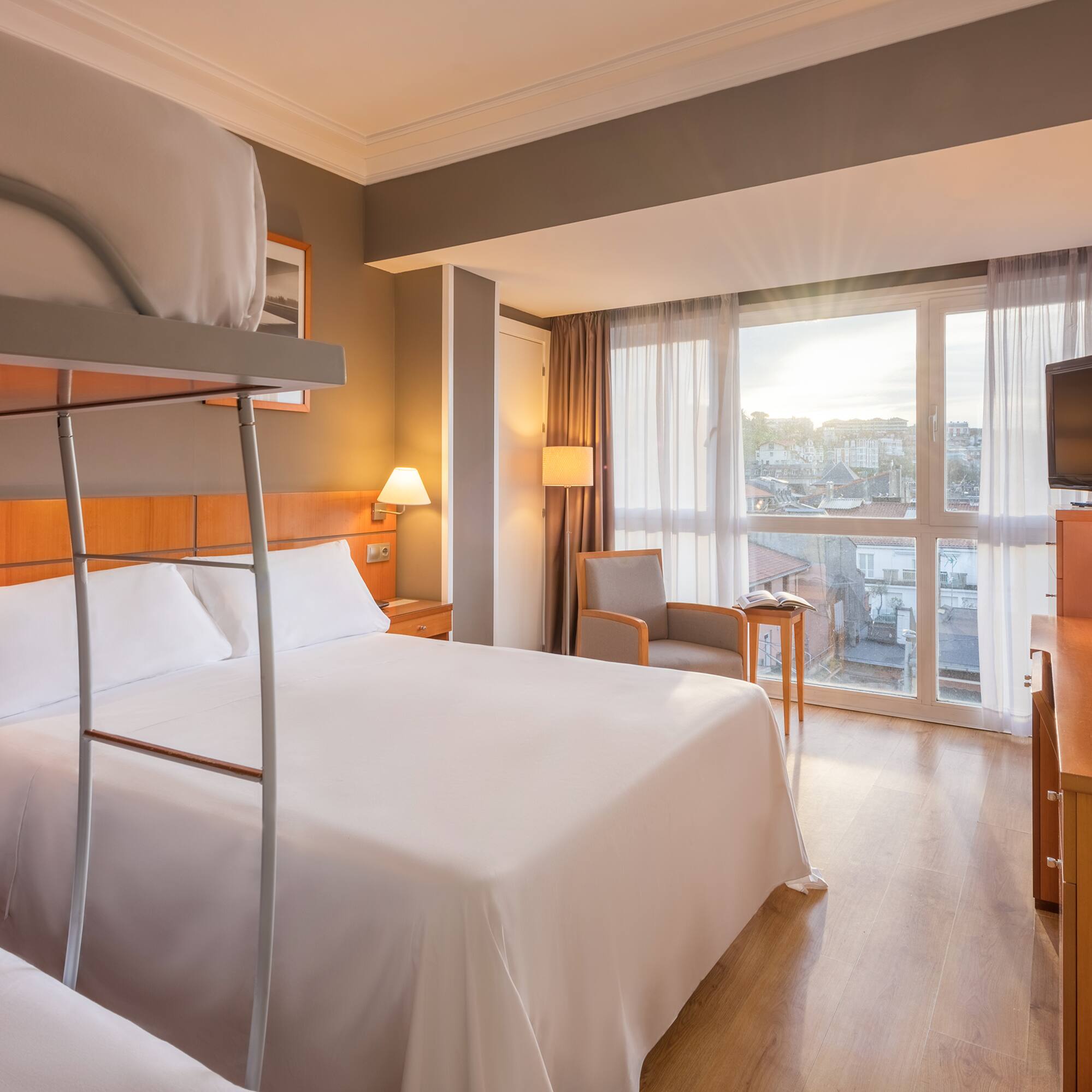 a room with bunk beds and a television