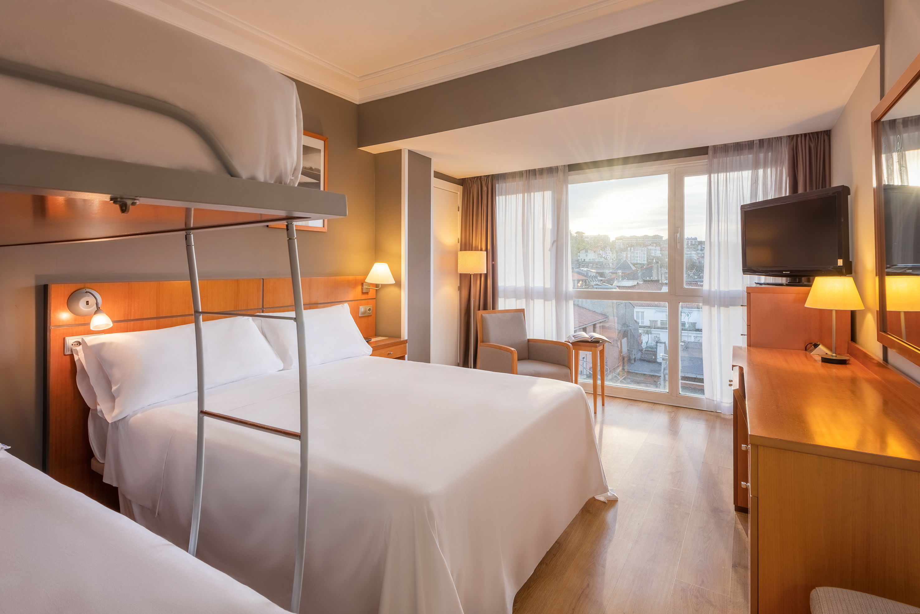 a room with bunk beds and a television