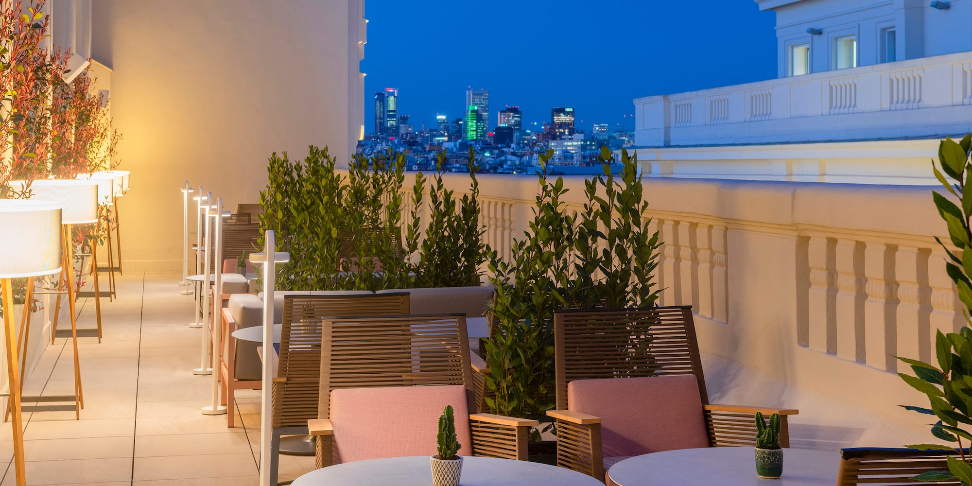 a patio with tables and chairs on a rooftop