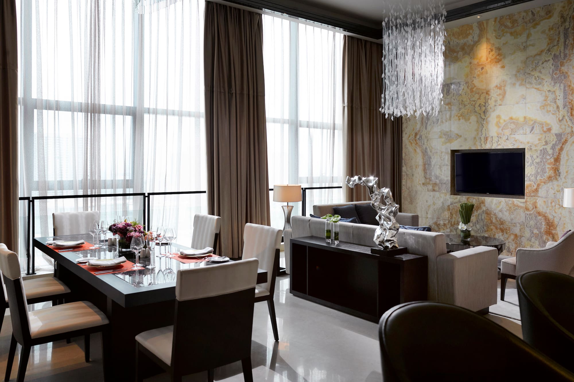 a living room with a table and chairs