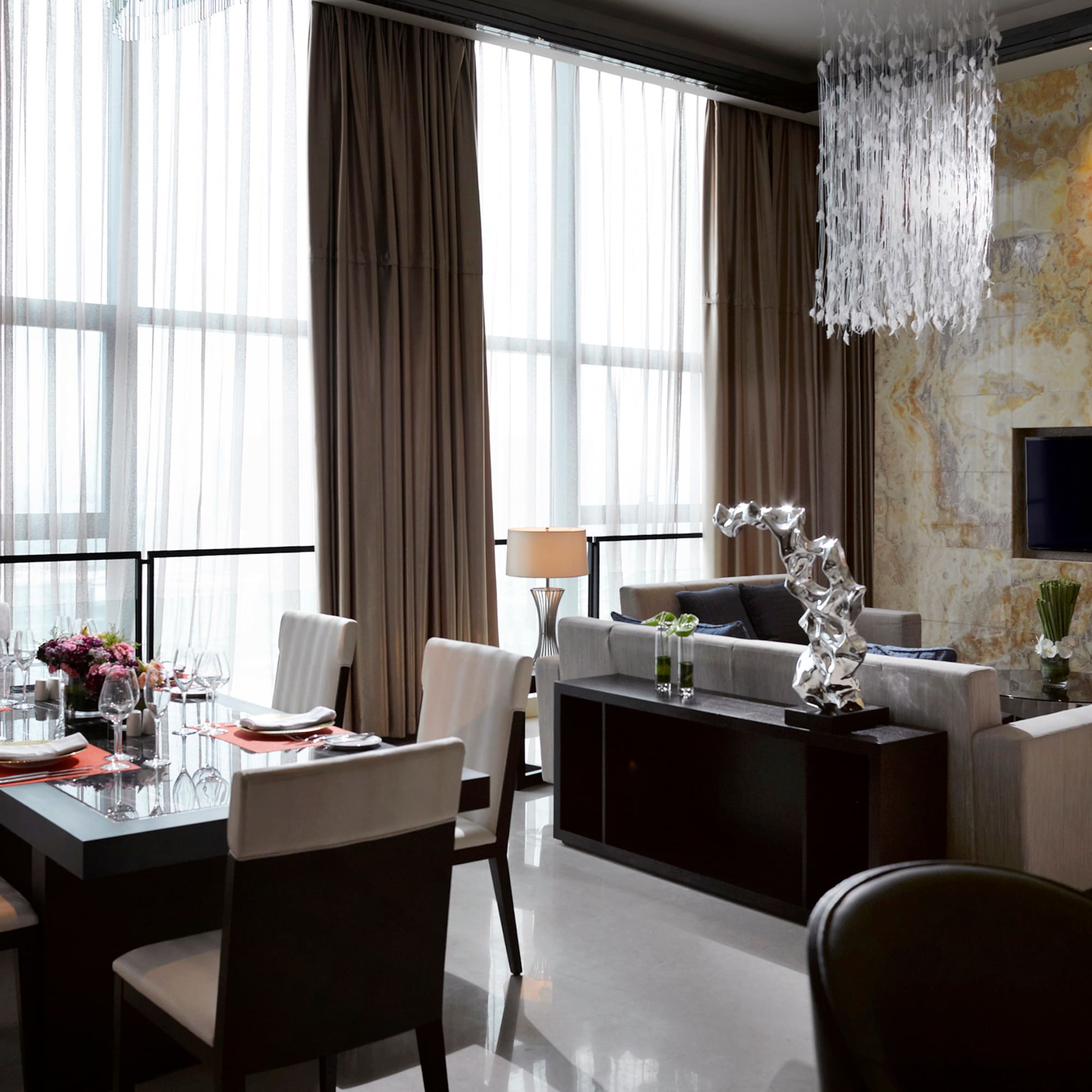 a living room with a table and chairs