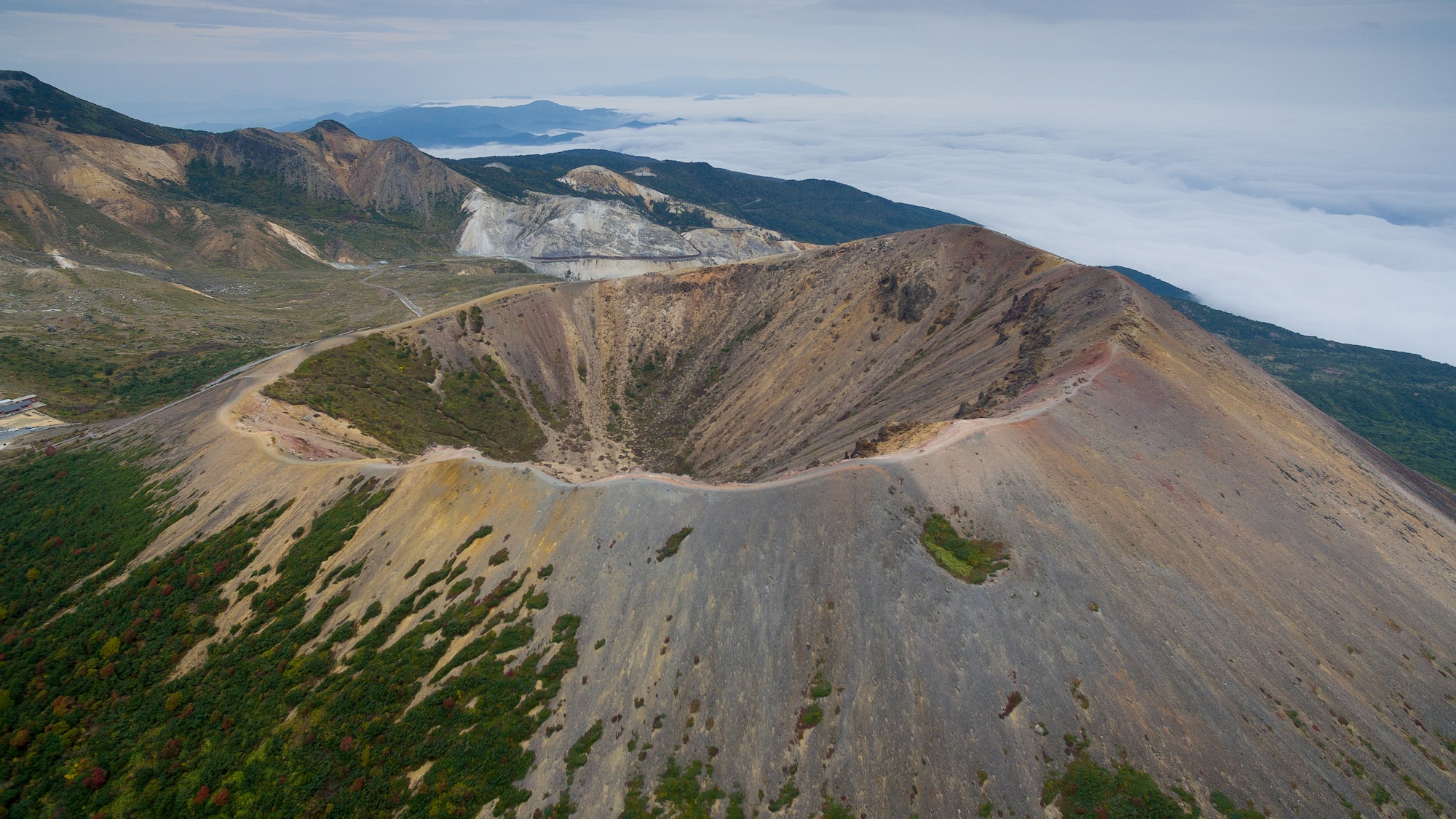 a mountain with a road and trees