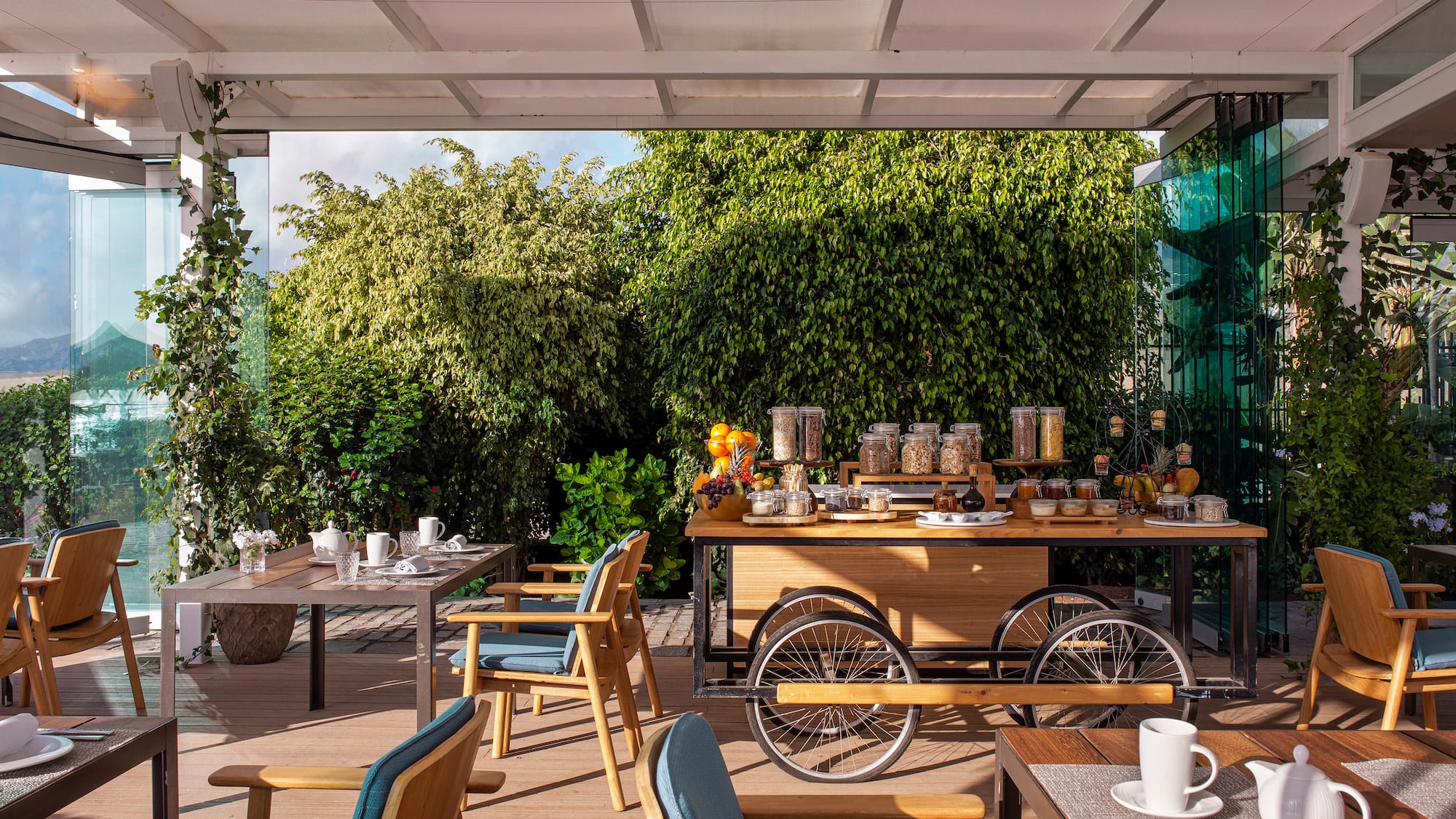 a table with food on it and chairs on a deck