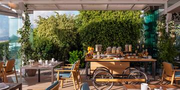 a table with food on it and chairs on a deck