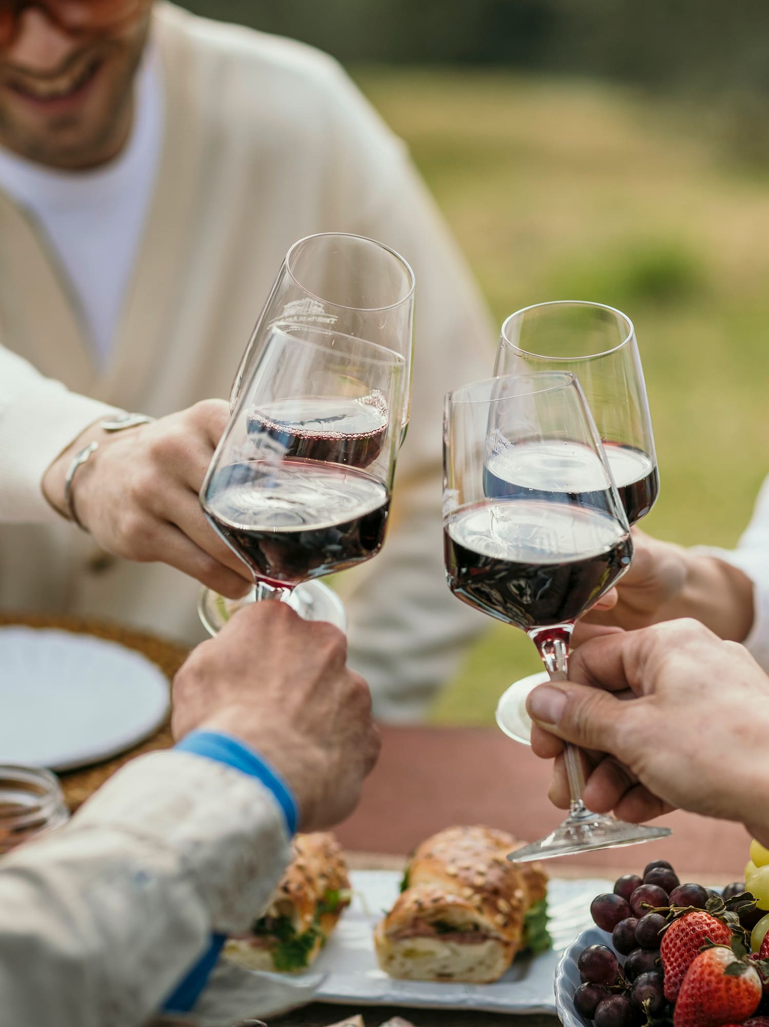 a group of people clinking wine glasses