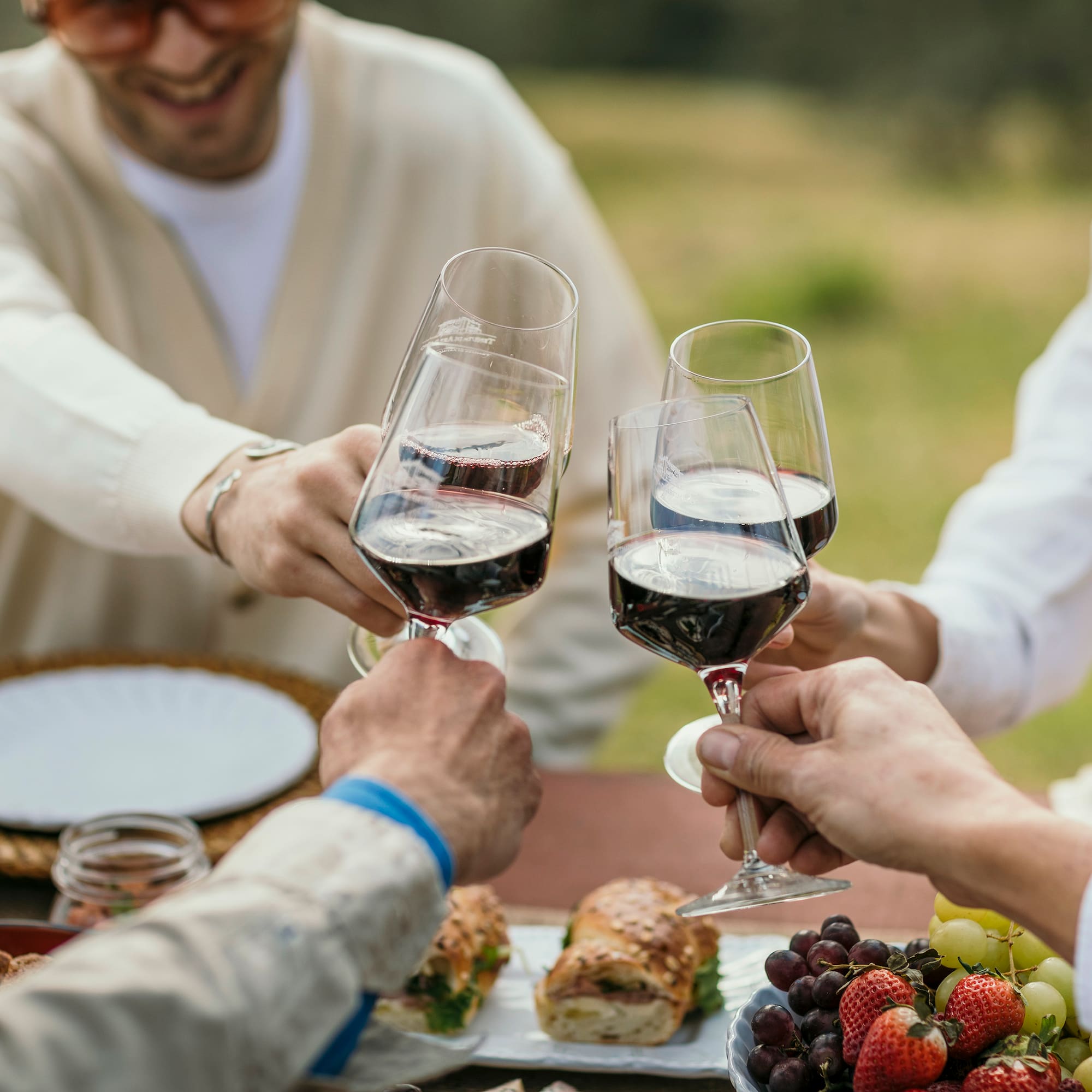 a group of people clinking wine glasses