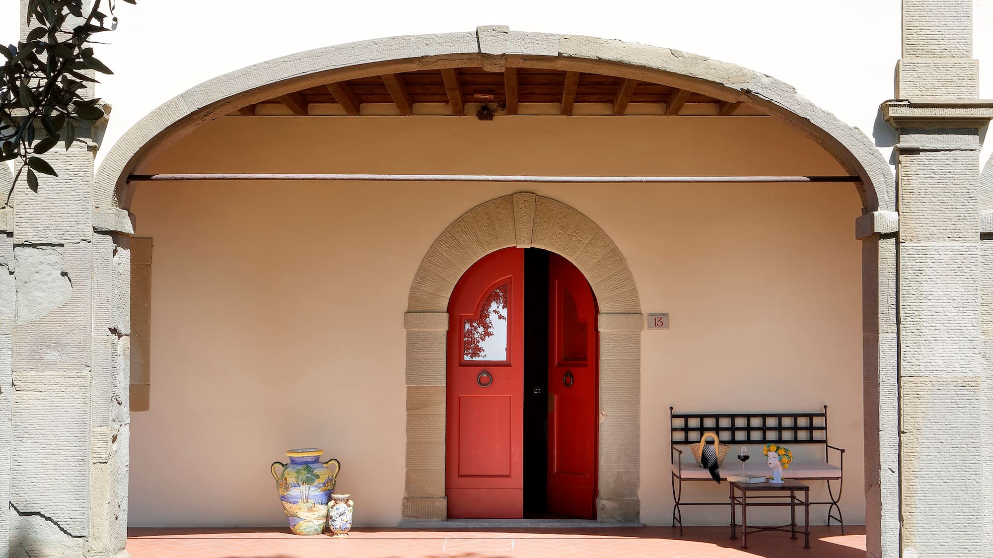a building with a red door and bench