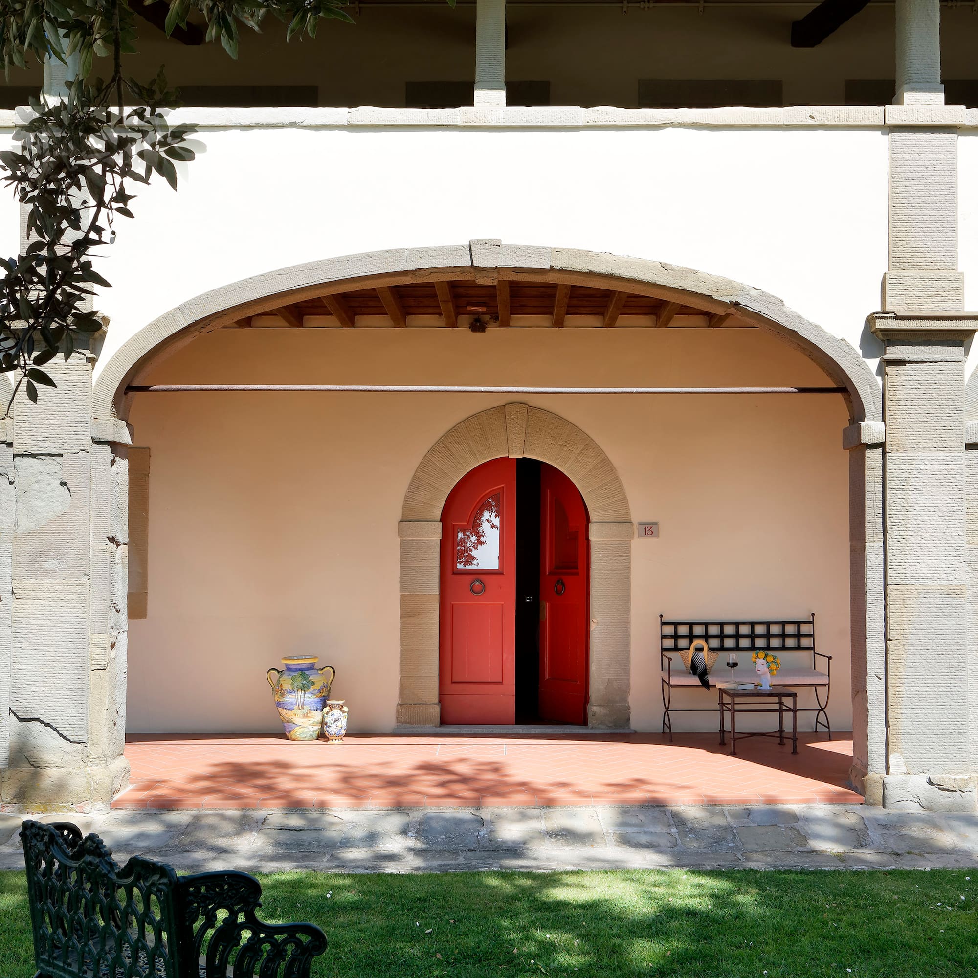 a building with a red door and bench