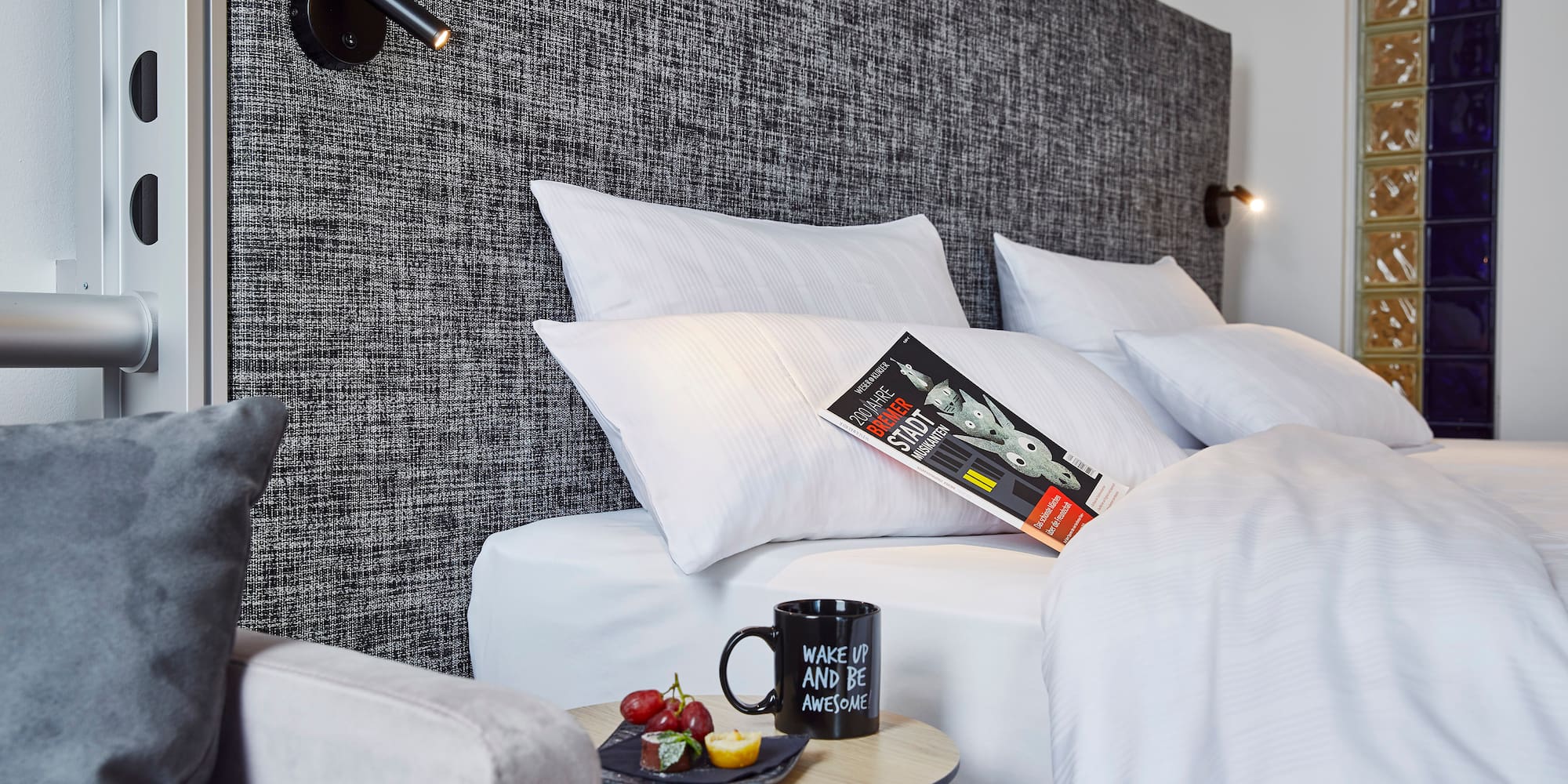 a bed with pillows and a book on it