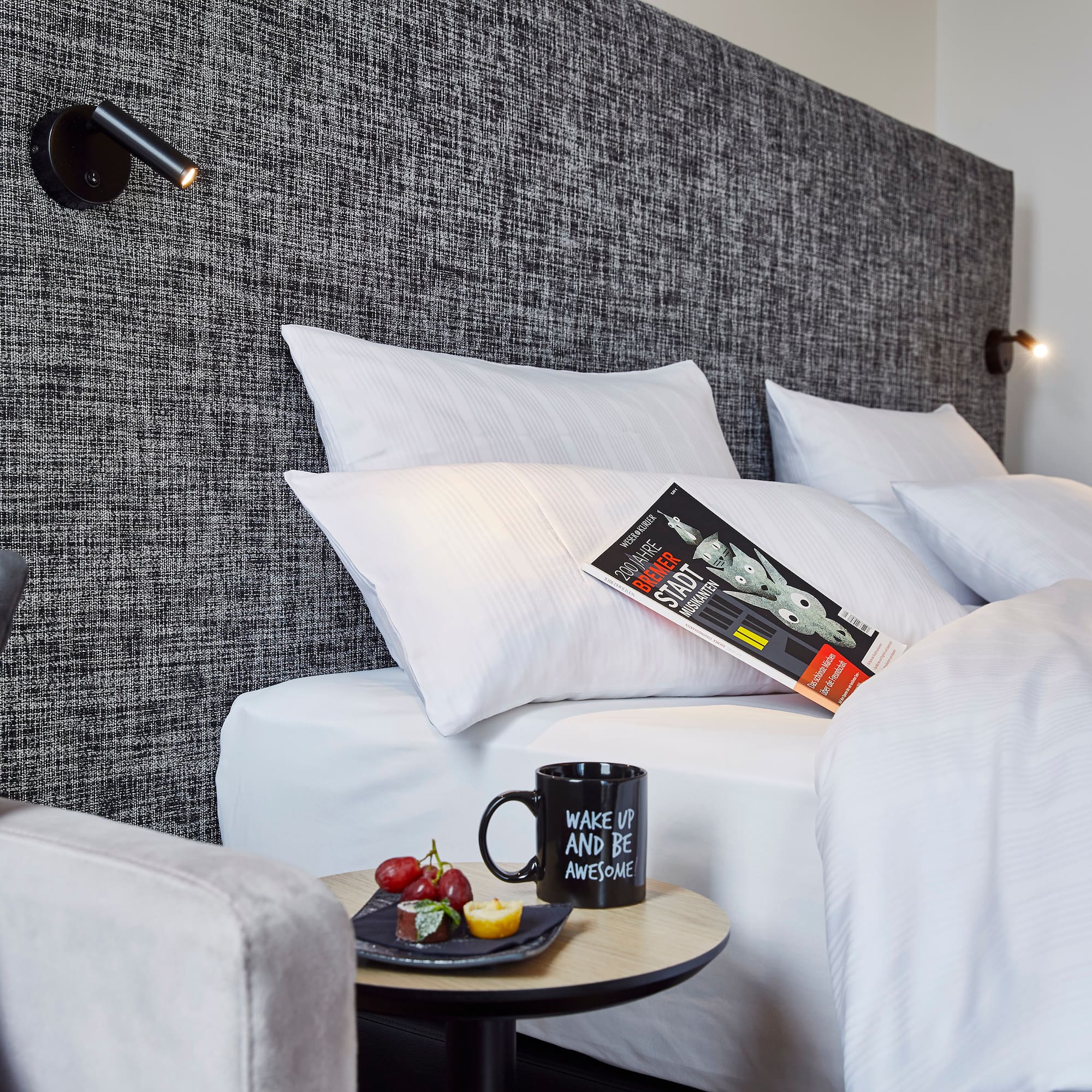 a bed with pillows and a book on it