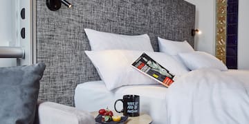 a bed with pillows and a book on it