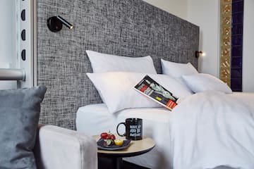 a bed with pillows and a book on it