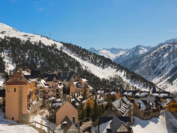 a group of buildings on a snowy mountain