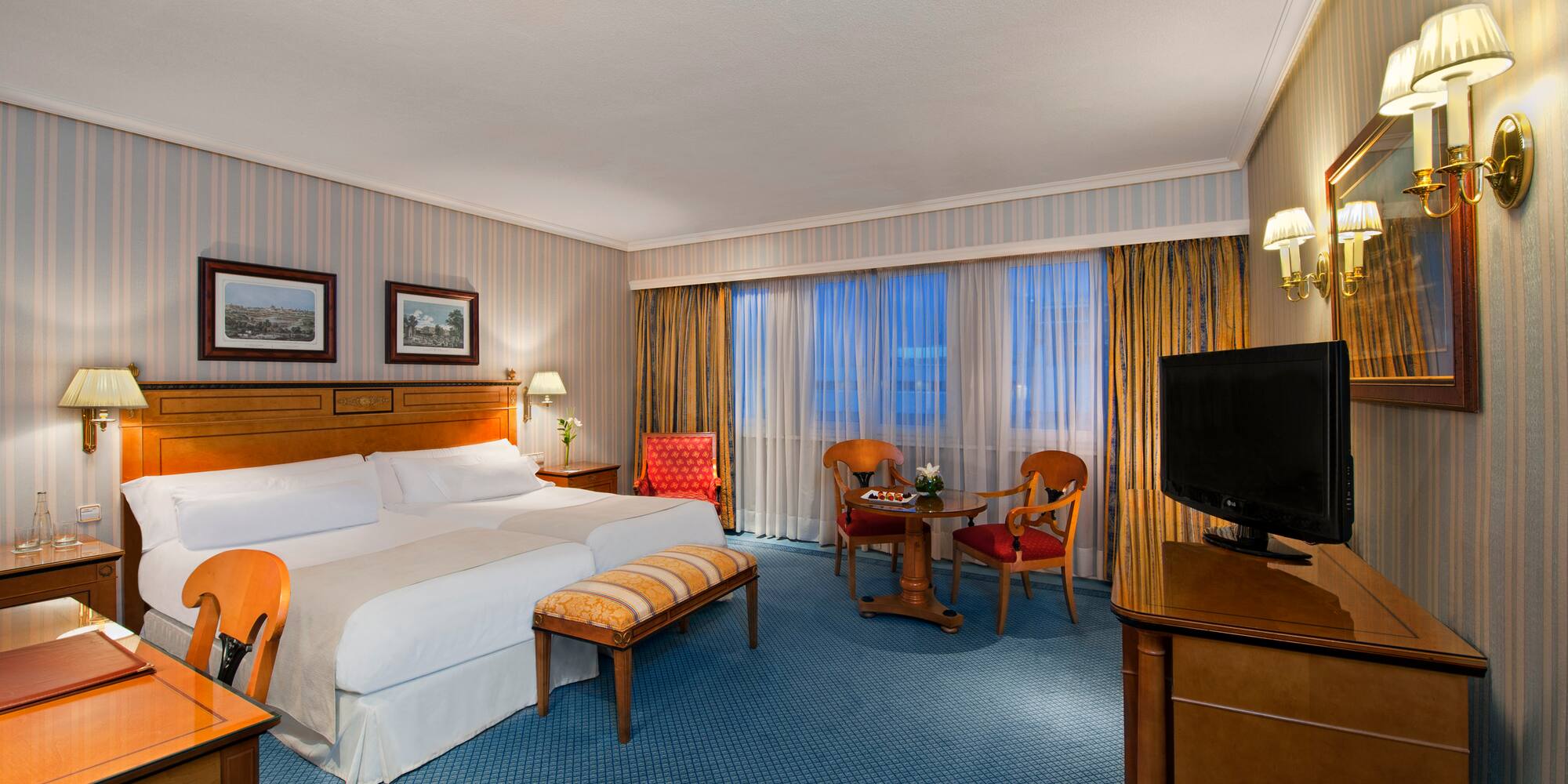 a room with a bed and a television