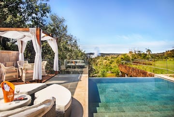 a pool with a deck and chairs