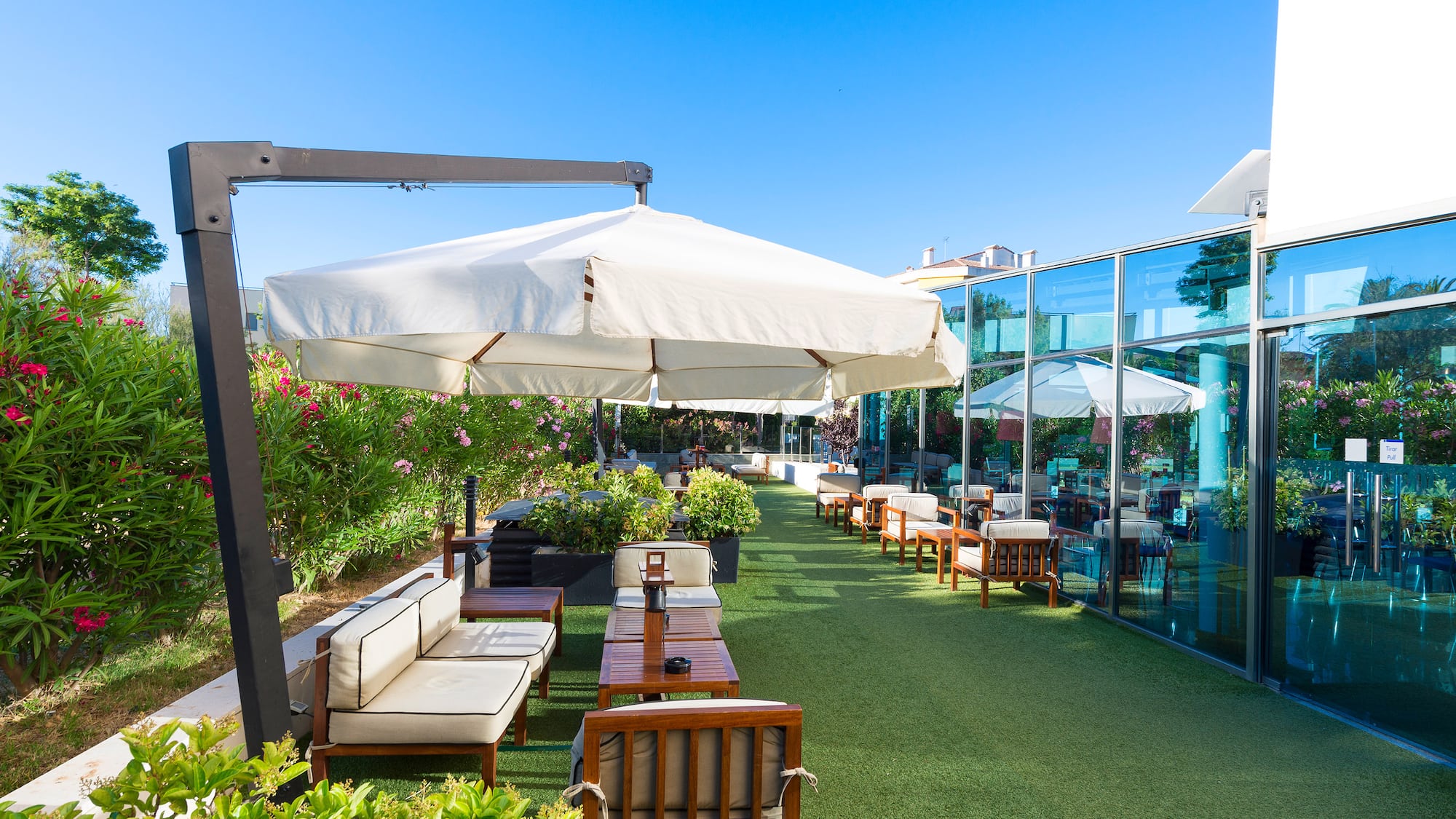 a patio area with chairs and umbrellas