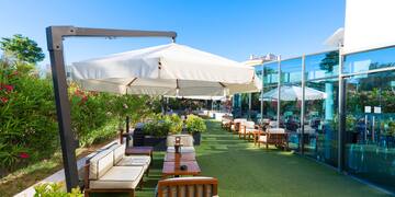 a patio area with chairs and umbrellas