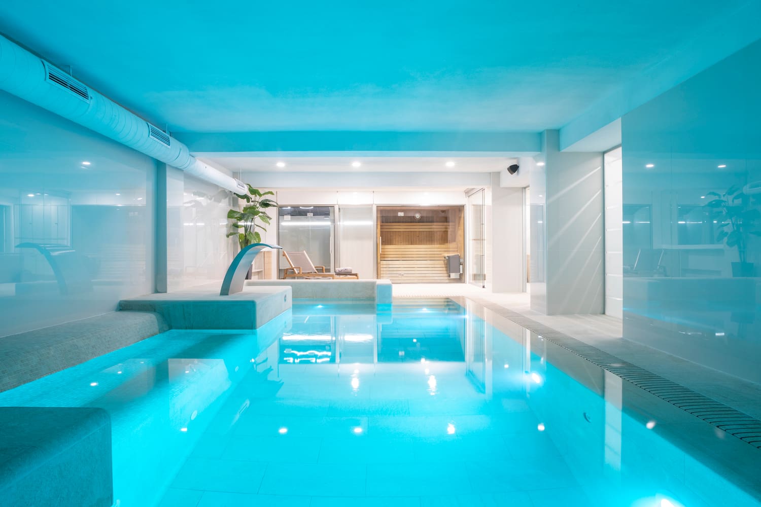 a indoor pool with a jacuzzi