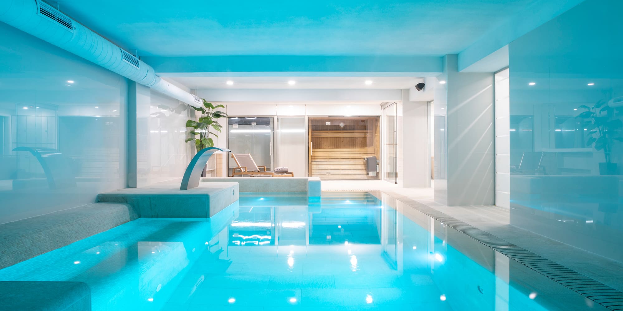a indoor pool with a jacuzzi