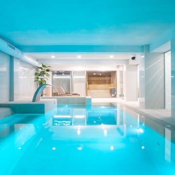 a indoor pool with a jacuzzi