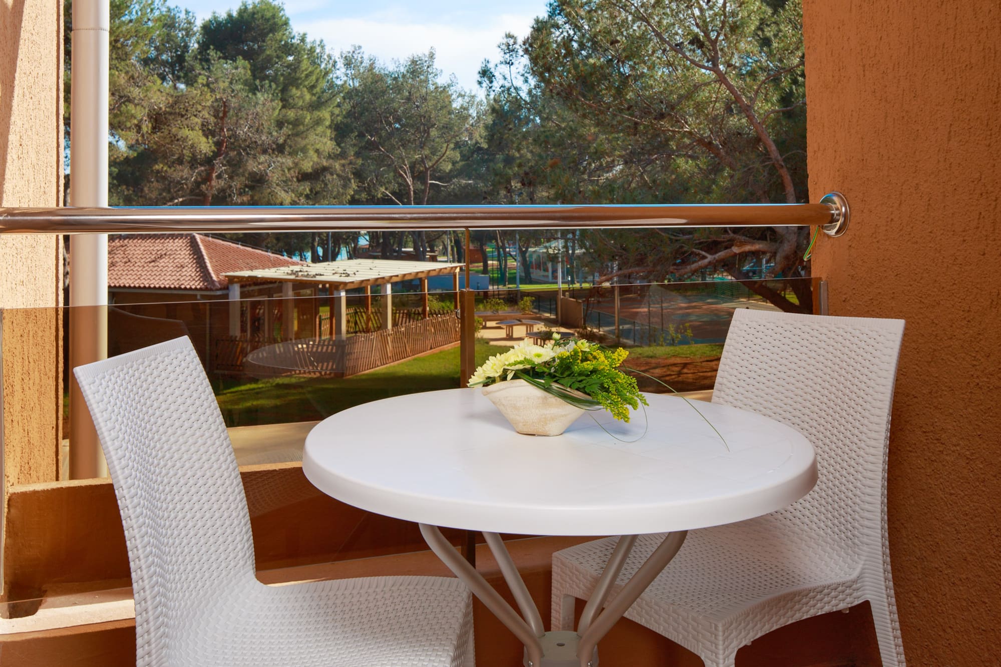a table and chairs outside a window