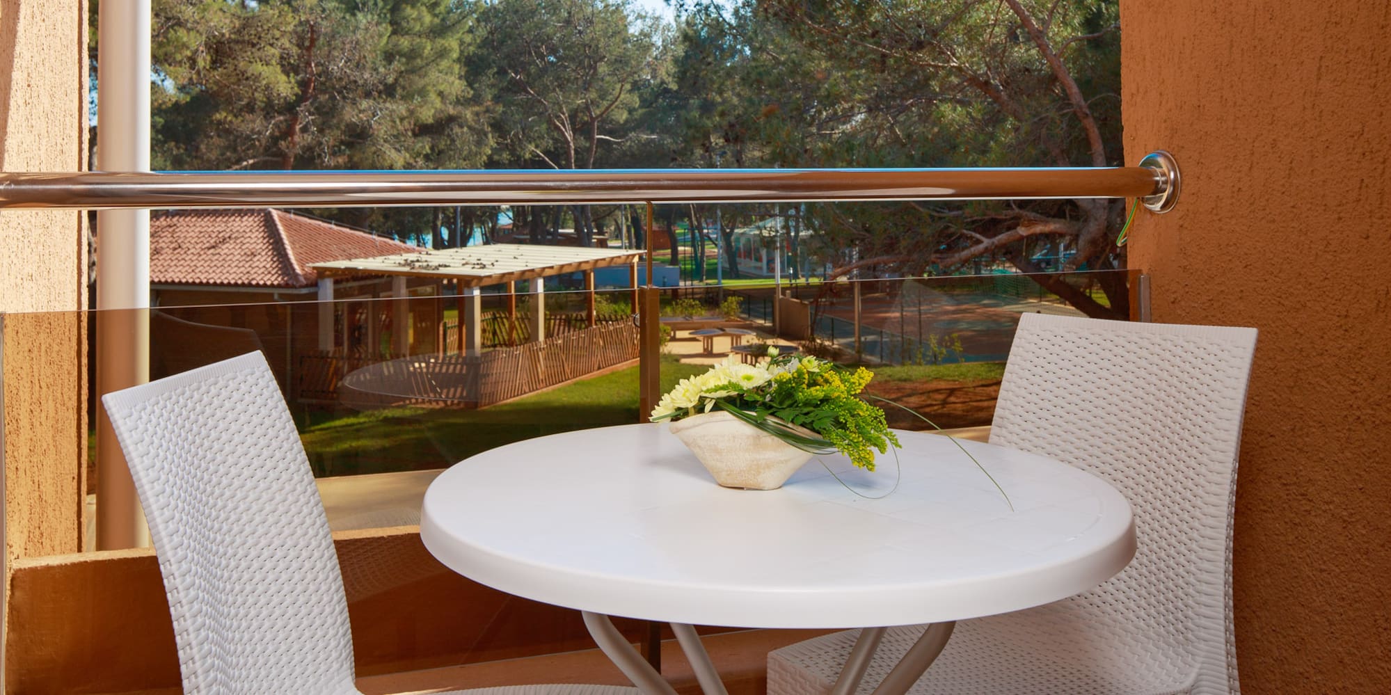 a table and chairs outside a window