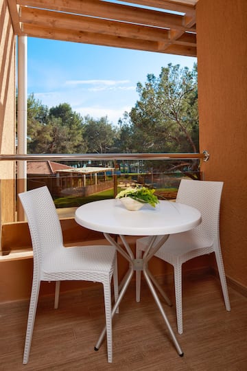 a table and chairs outside a window