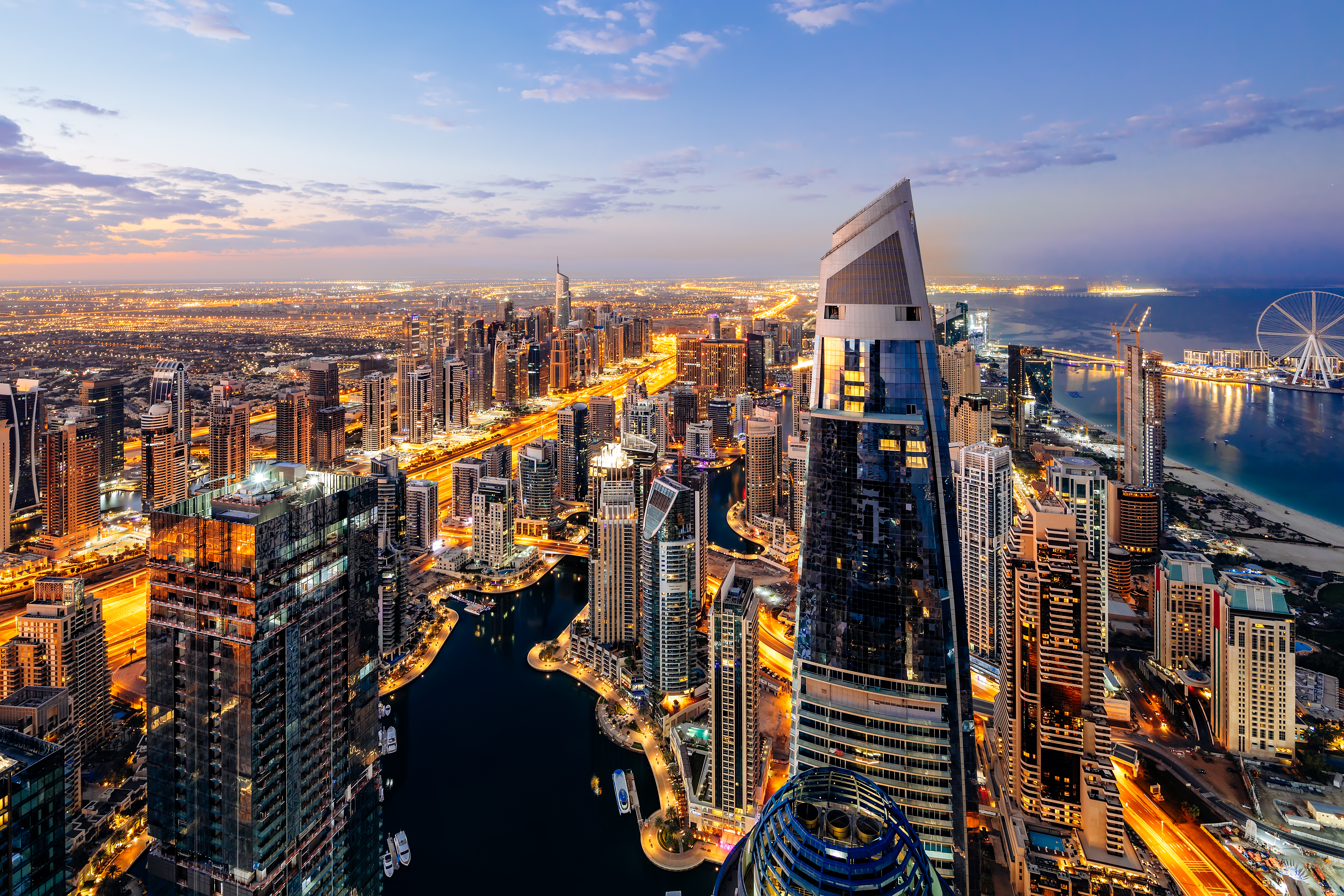 a city with many tall buildings and a river