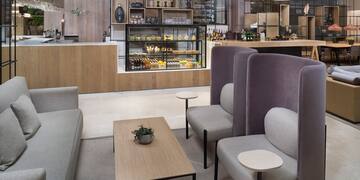 a room with a coffee table and chairs