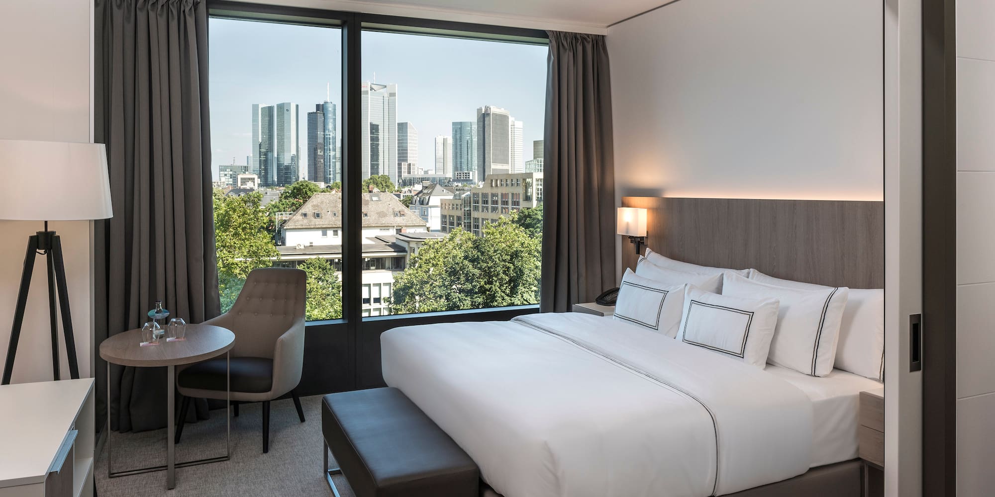 a bedroom with a bed and a table and chairs